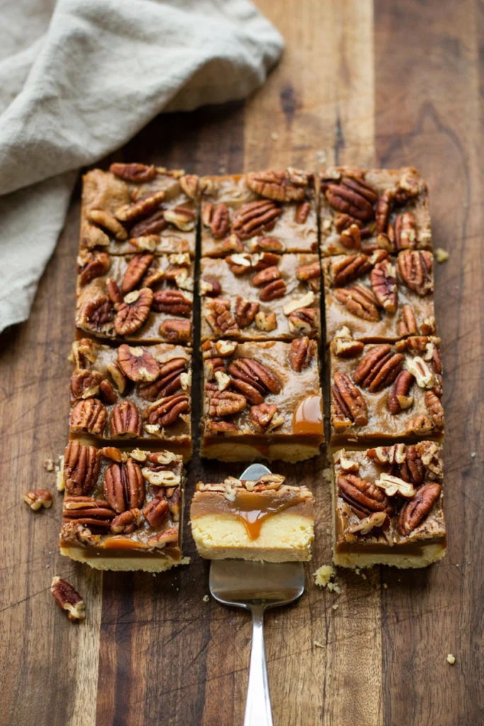 Toffee pecan bars cut into squares showing the shortbread base and toasted pecan top
