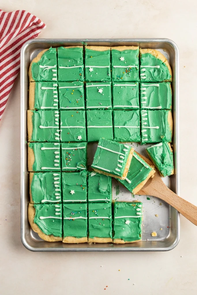 Football field sugar cookie bars with green frosting and white yard lines