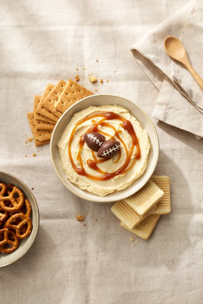 Football cheesecake dip with caramel swirl and graham crackers