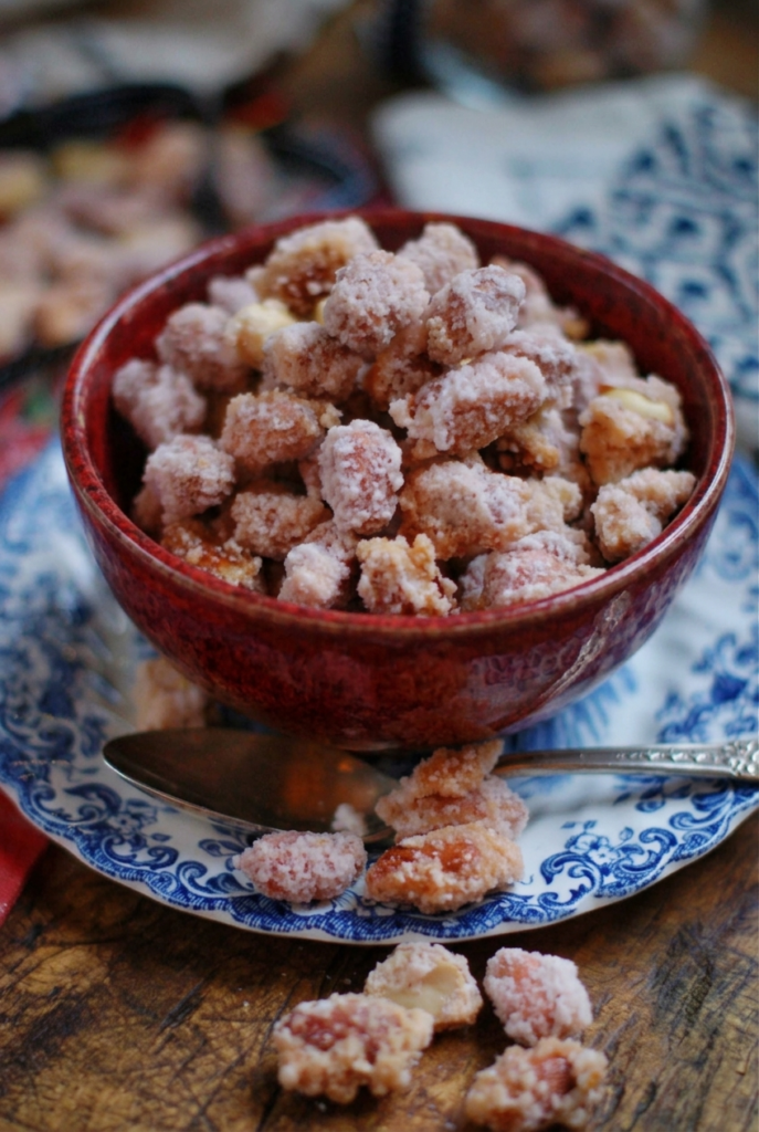 Red bowl of old-fashioned candied peanuts with a glossy caramelized sugar coating