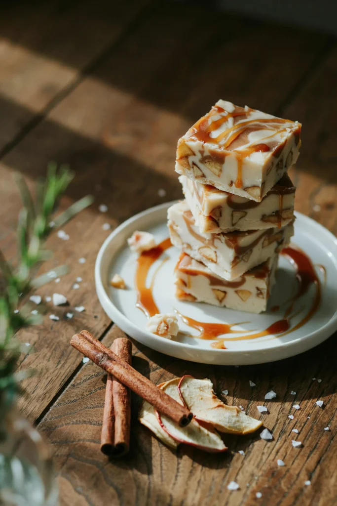 Stack of marbled caramel apple fudge squares with dried apple flecks