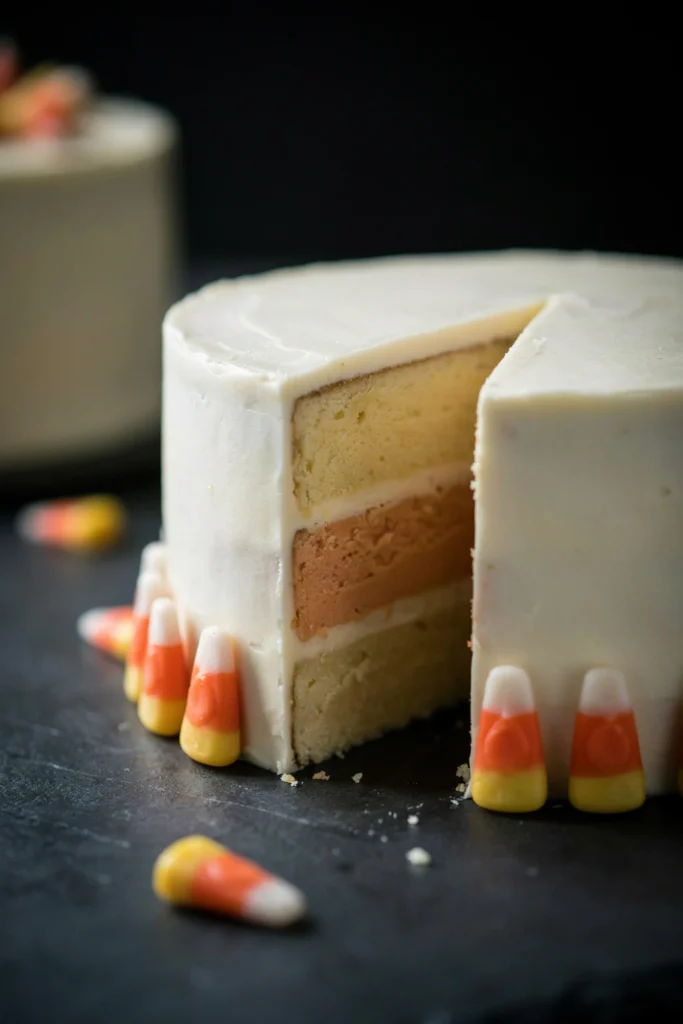 Sliced layer cake showing yellow, orange, and white bands like a candy corn kernel