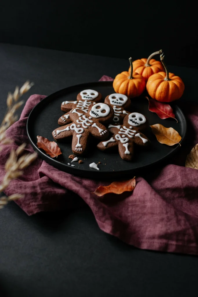 Black cookies cut into gingerbread-man shapes with piped white bone icing detail