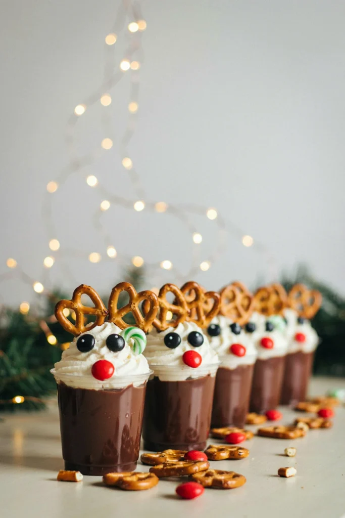 Clear cups of chocolate pudding topped with whipped cream and decorated as reindeer