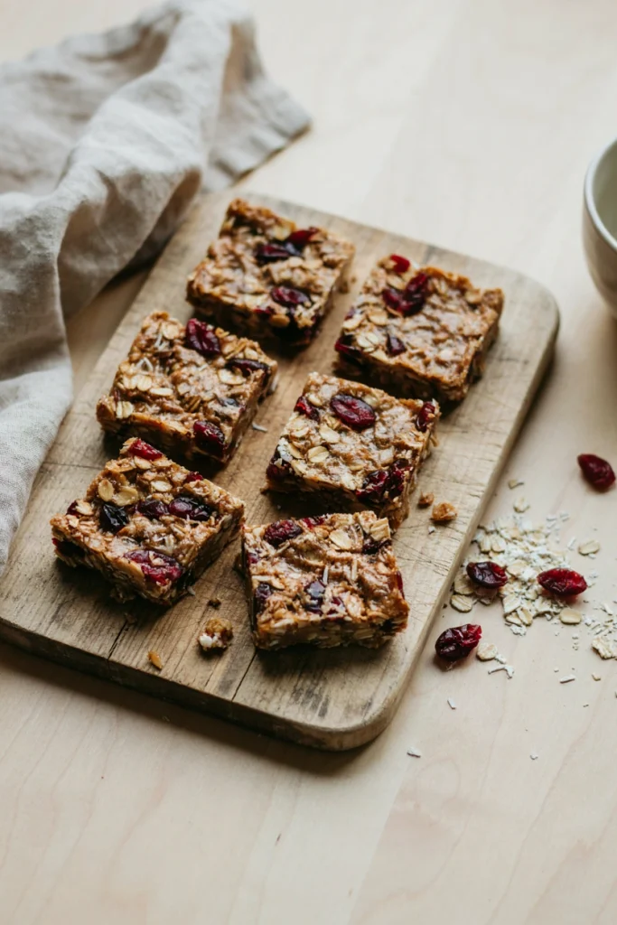 Chewy no-bake bars packed with coconut and dried cranberries, cut into squares