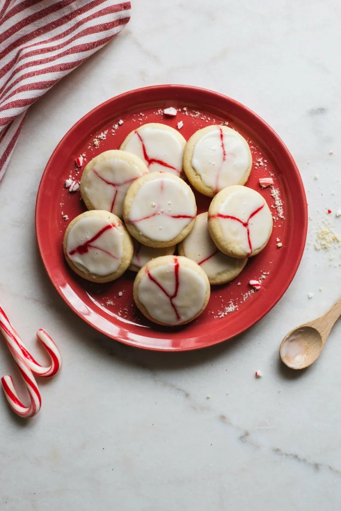 Candy cane sugar cookies with red and white swirled royal icing